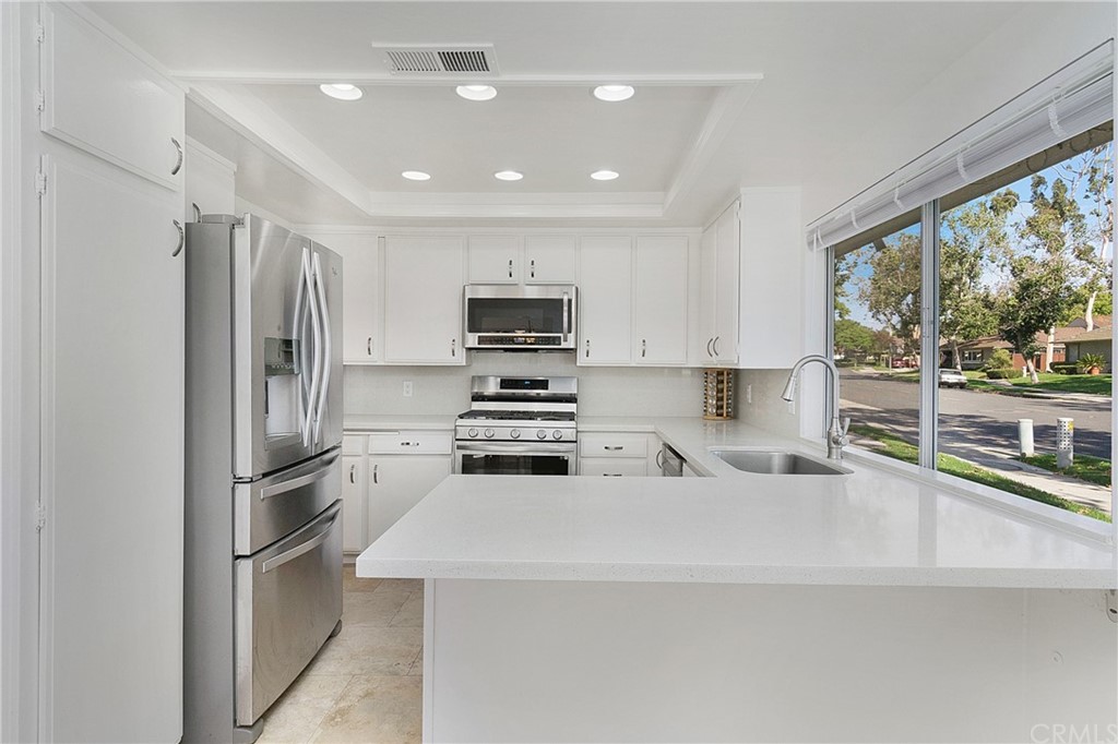 17241 Candleberry Irvine, CA 92612 - Photo 6 of 24 a kitchen with stainless steel appliances a refrigerator sink and stove