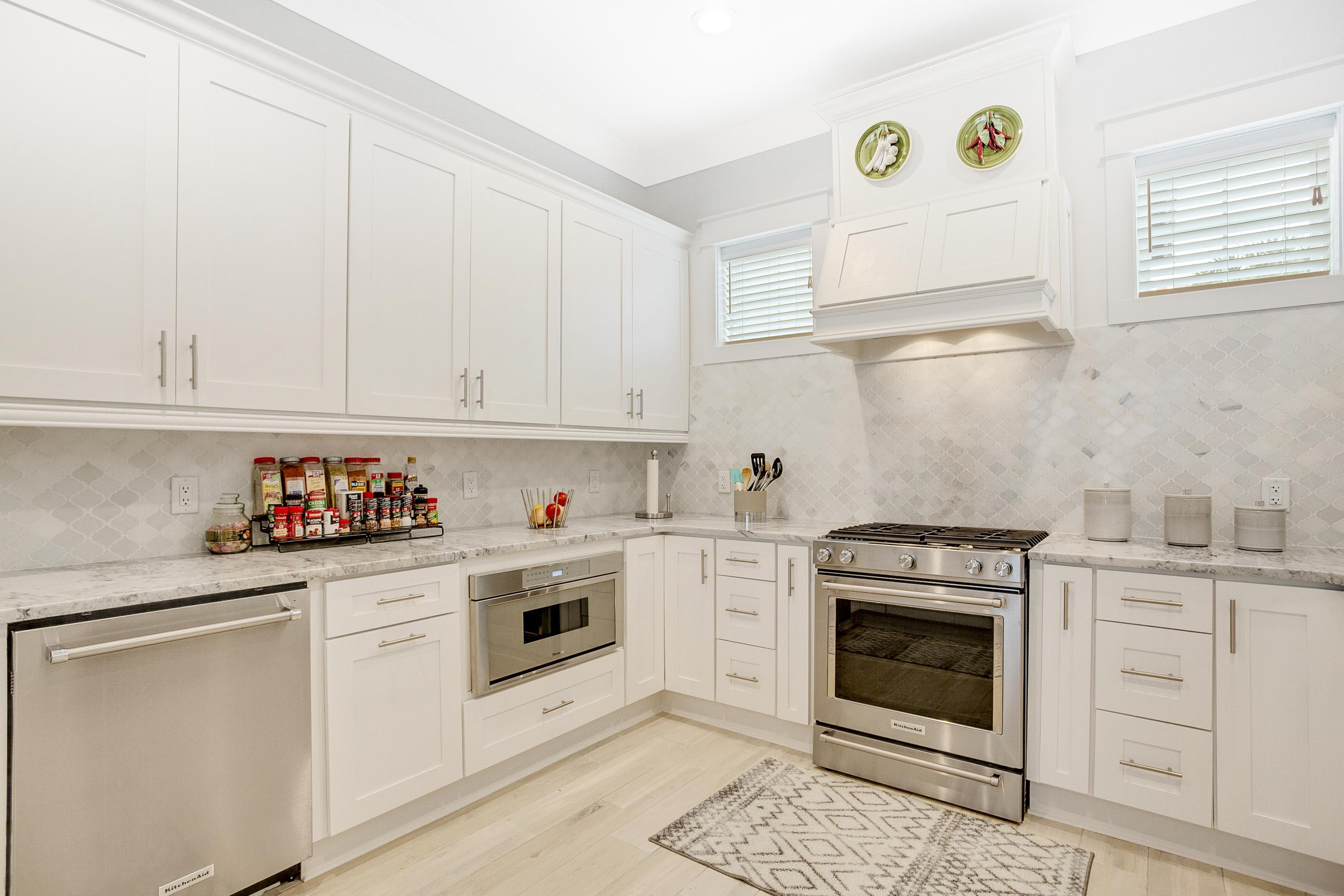 4795 Ocean Boulevard Destin, FL 32541 - Photo 11 of 43 a kitchen with granite countertop white cabinets and white appliances