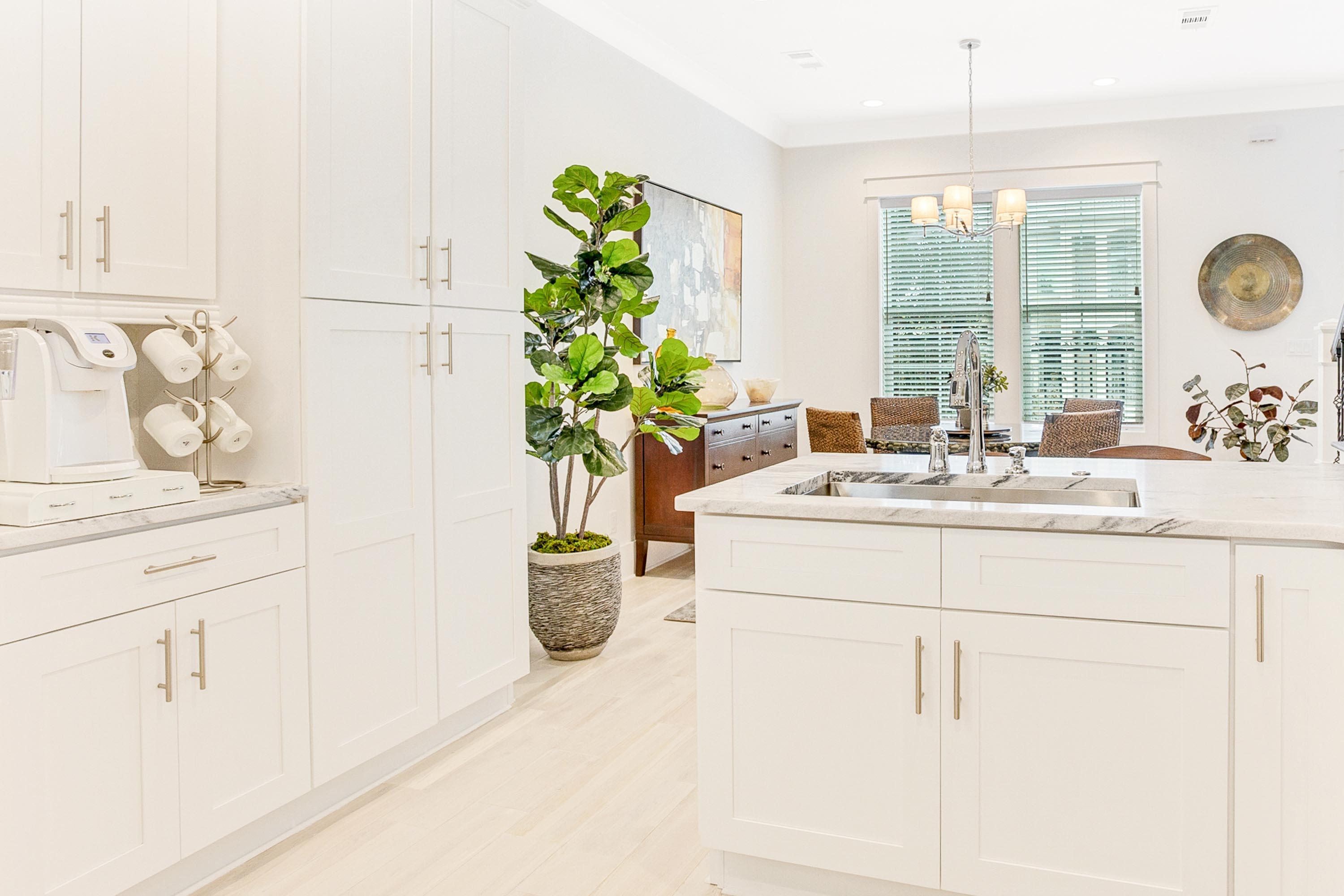 4795 Ocean Boulevard Destin, FL 32541 - Photo 14 of 43 a dining table with potted plant on the counter and mirror