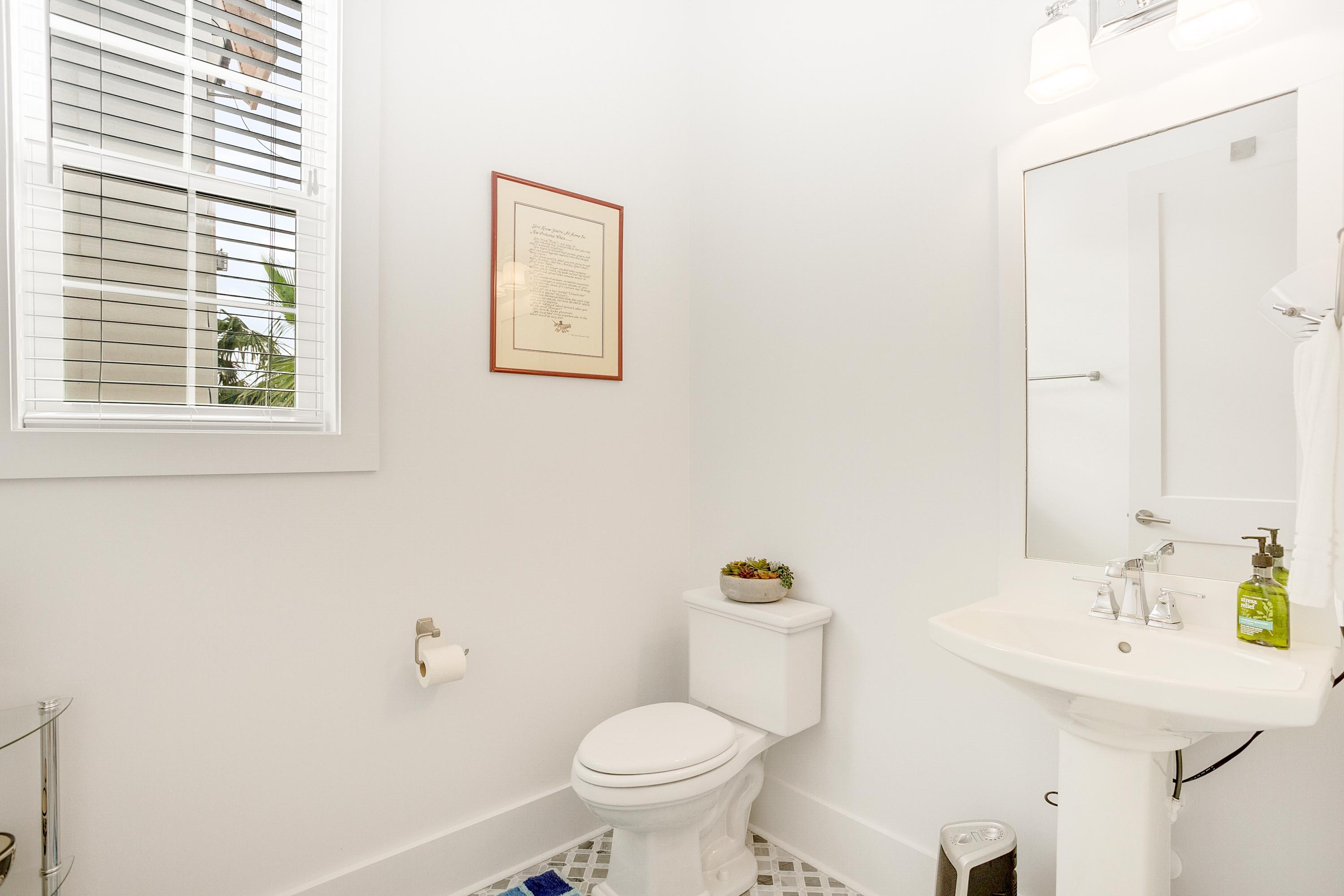 4795 Ocean Boulevard Destin, FL 32541 - Photo 16 of 43 a bathroom with a toilet sink and mirror