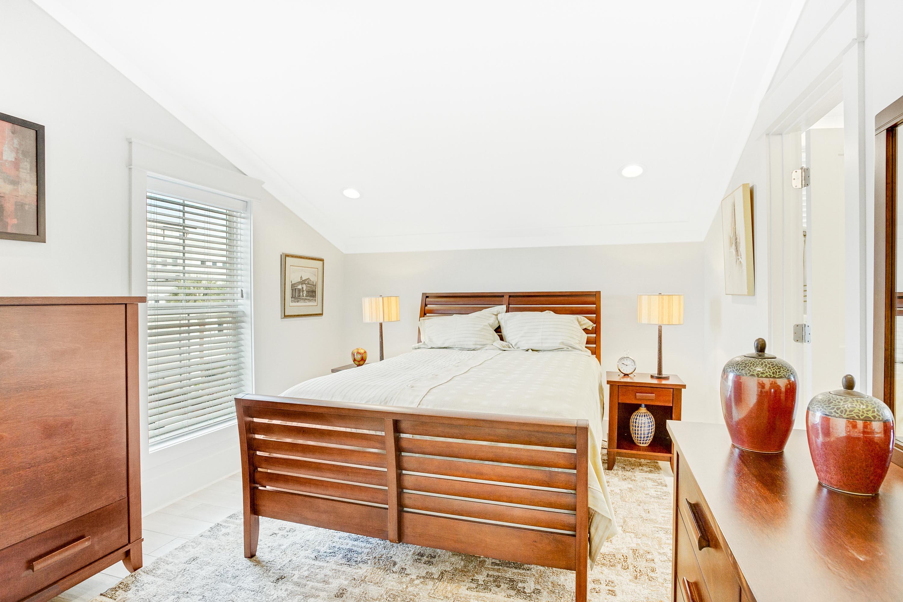 4795 Ocean Boulevard Destin, FL 32541 - Photo 22 of 43 a bedroom with a bed and wooden floor