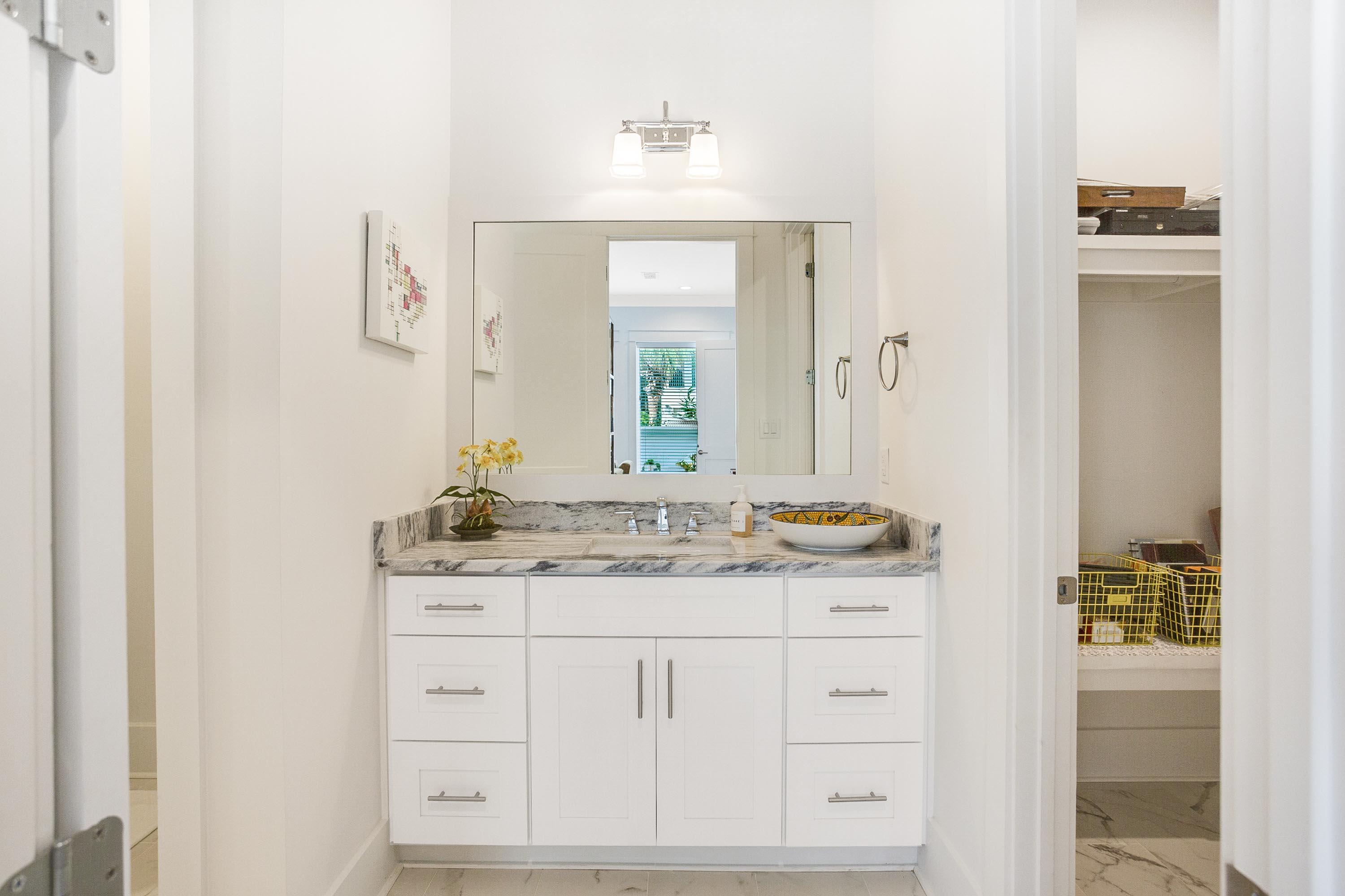 4795 Ocean Boulevard Destin, FL 32541 - Photo 28 of 43 a bathroom with a granite countertop sink and a mirror