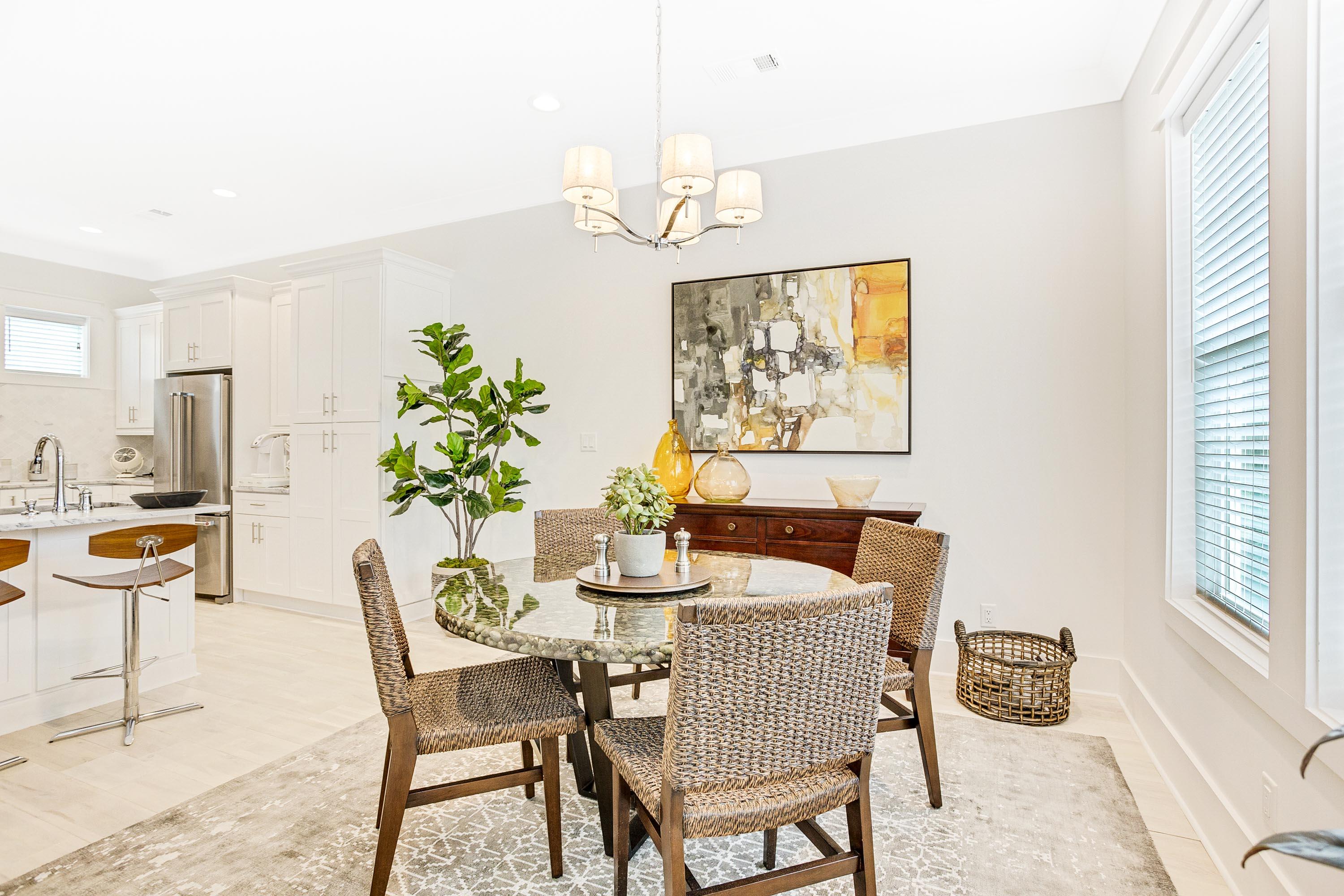 4795 Ocean Boulevard Destin, FL 32541 - Photo 10 of 43 a dining room with furniture a rug and a chandelier