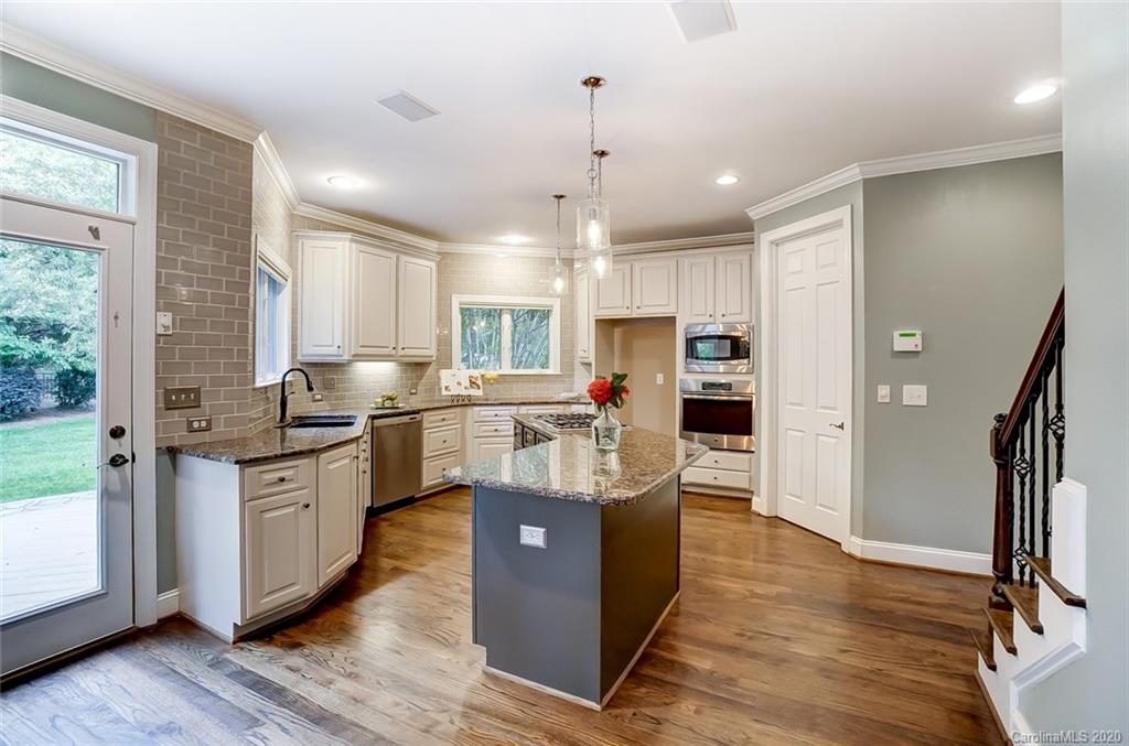 18408 Dembridge Drive, Unit 21 Davidson, NC 28036 - Photo 12 of 34 a kitchen with stainless steel appliances granite countertop a refrigerator a stove a sink and a hard wood floors