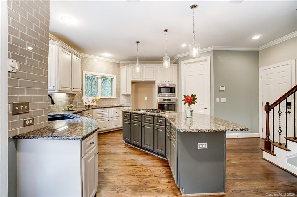 18408 Dembridge Drive, Unit 21 Davidson, NC 28036 - Photo 13 of 34 a kitchen with kitchen island granite countertop a sink appliances and cabinets