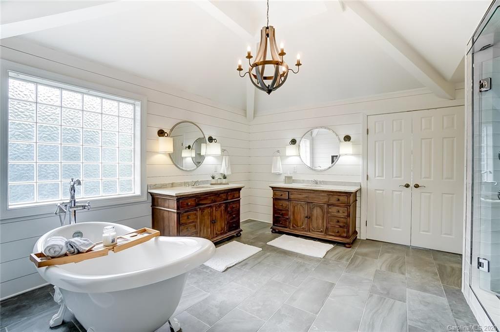 18408 Dembridge Drive, Unit 21 Davidson, NC 28036 - Photo 18 of 34 a living room with furniture a table and a fireplace