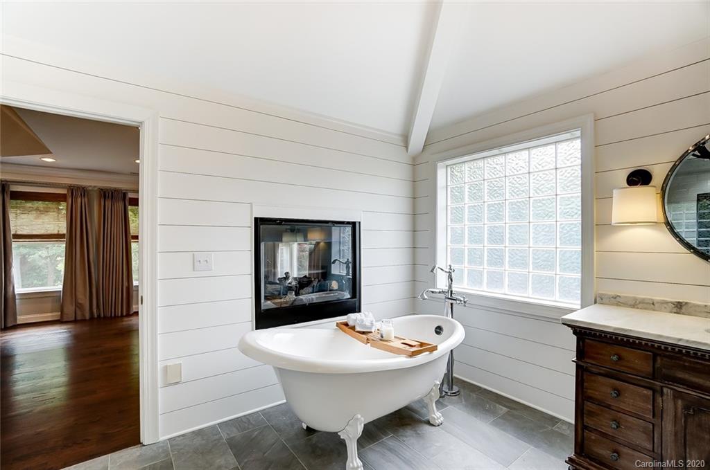 18408 Dembridge Drive, Unit 21 Davidson, NC 28036 - Photo 19 of 34 a bathroom with a sink a bathtub and a window
