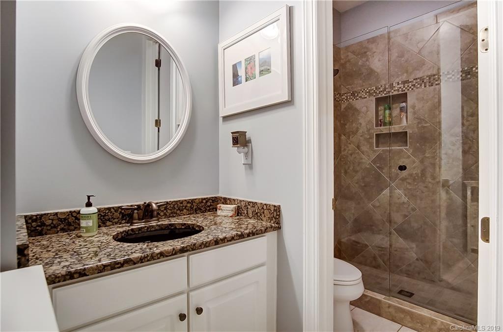 18408 Dembridge Drive, Unit 21 Davidson, NC 28036 - Photo 22 of 34 a bathroom with a sink and a mirror