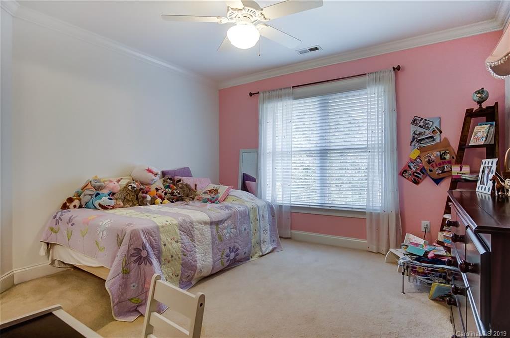 18408 Dembridge Drive, Unit 21 Davidson, NC 28036 - Photo 29 of 34 a bedroom with a bed and a window