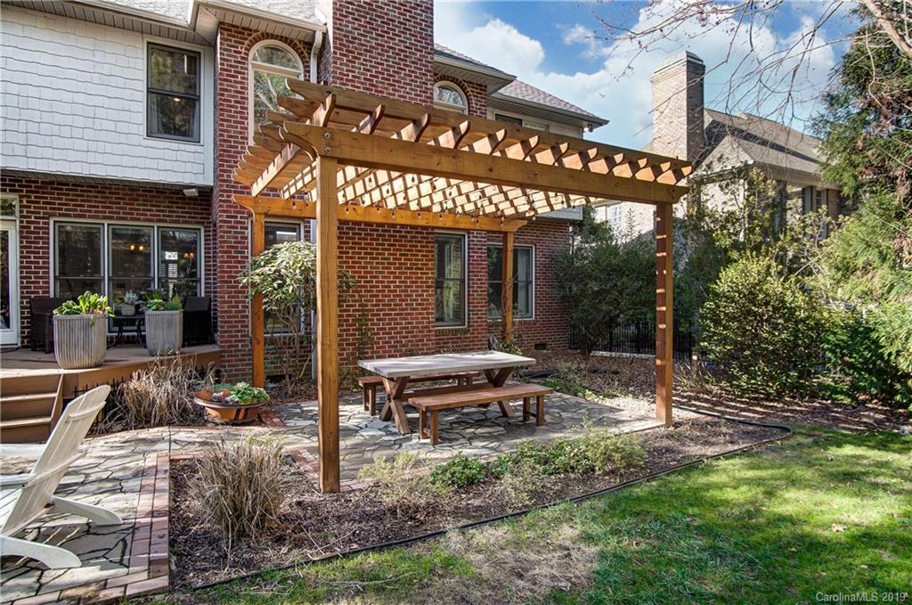 18408 Dembridge Drive, Unit 21 Davidson, NC 28036 - Photo 32 of 34 a view of a cafe with a table and chairs and potted plants