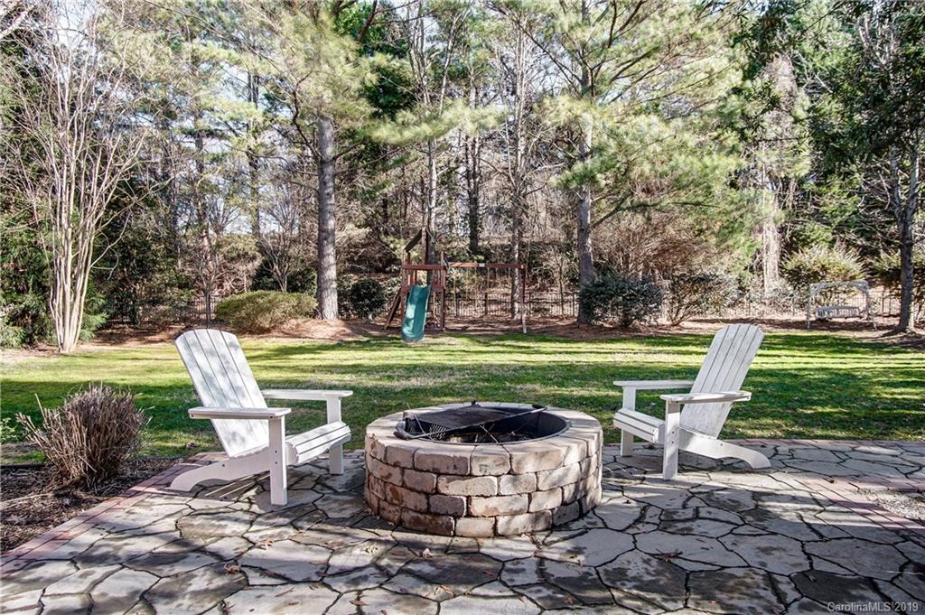 18408 Dembridge Drive, Unit 21 Davidson, NC 28036 - Photo 34 of 34 a view of a table and chairs in the garden