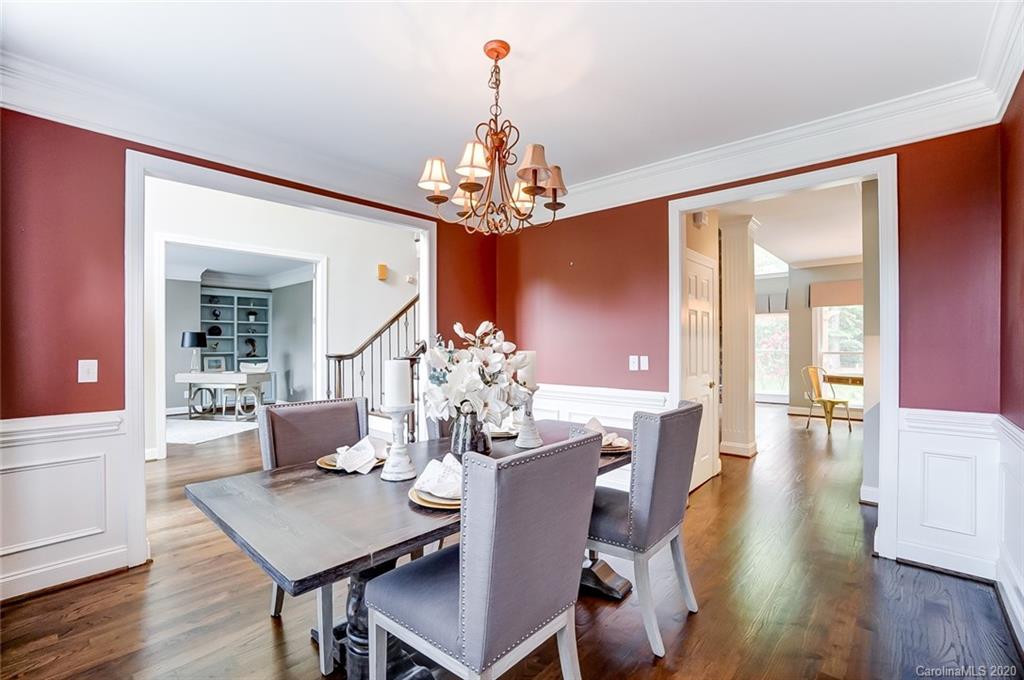 18408 Dembridge Drive, Unit 21 Davidson, NC 28036 - Photo 5 of 34 a view of a dining room with furniture a chandelier and wooden floor