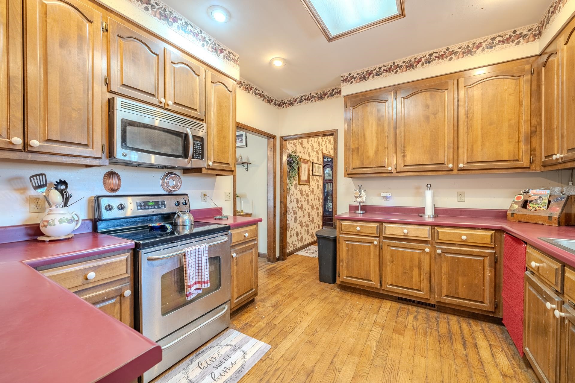 645 Wildflower Ridge Lane Savannah, TN 38372 - Photo 21 of 40 a kitchen with stainless steel appliances granite countertop a stove a sink and a microwave