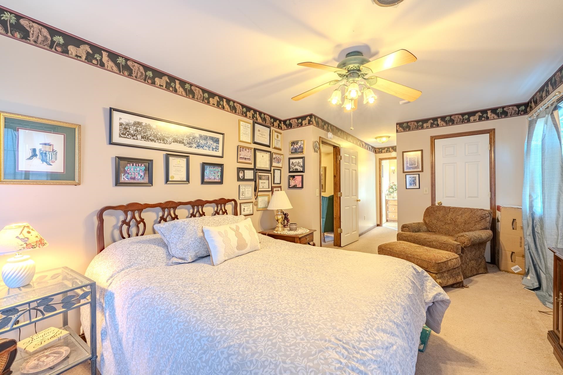 645 Wildflower Ridge Lane Savannah, TN 38372 - Photo 34 of 40 a bedroom with a bed and a chandelier