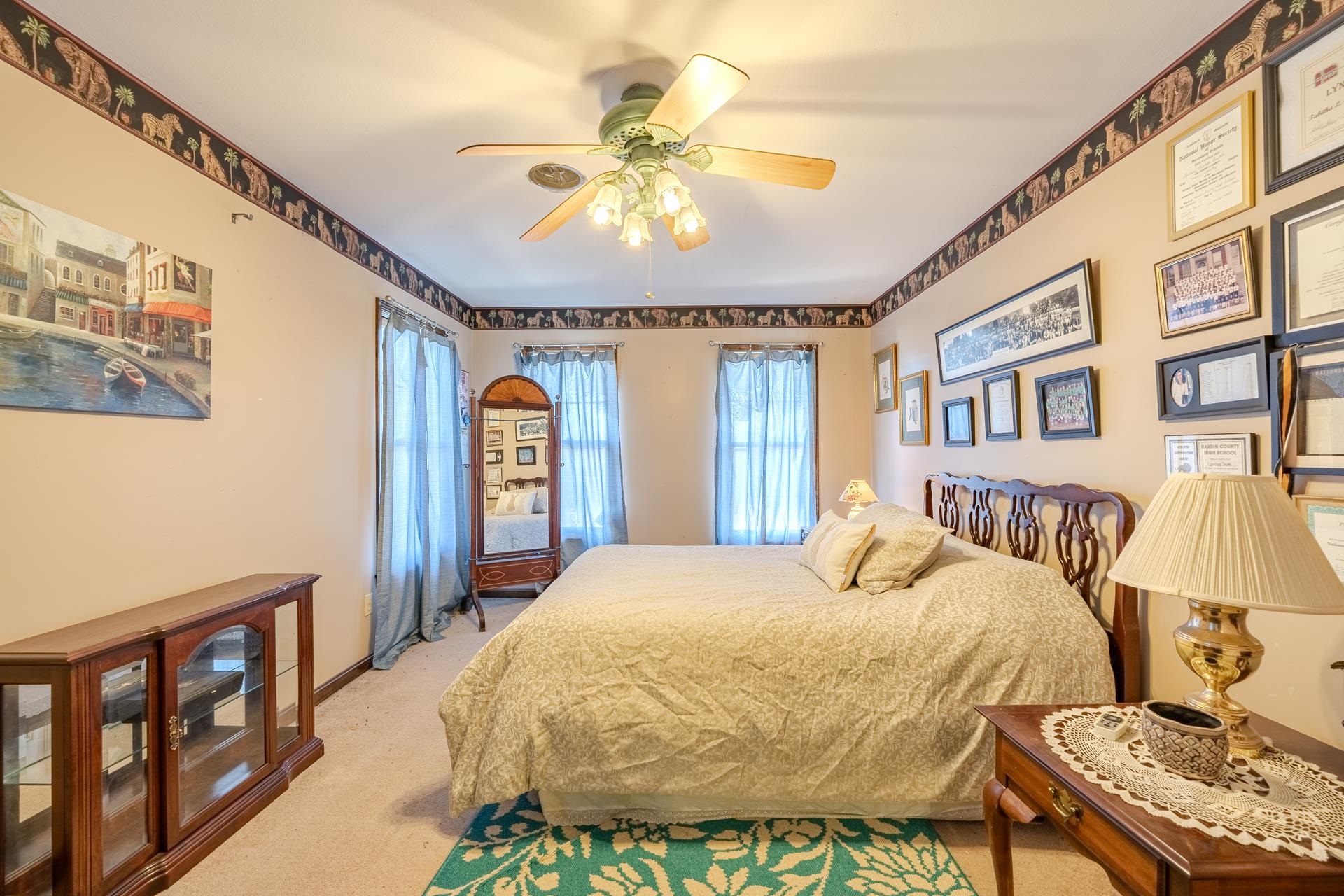 645 Wildflower Ridge Lane Savannah, TN 38372 - Photo 35 of 40 a bedroom with a bed and a chandelier