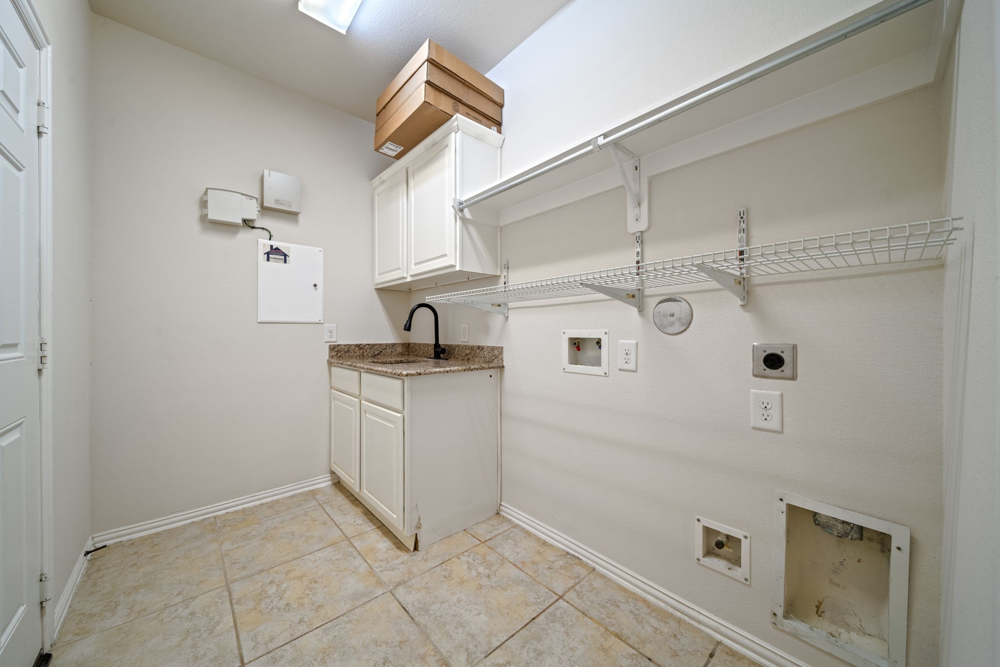 8115 Spreadwing Street Conroe, TX 77385 - Photo 14 of 45 a kitchen with cabinets and white appliances