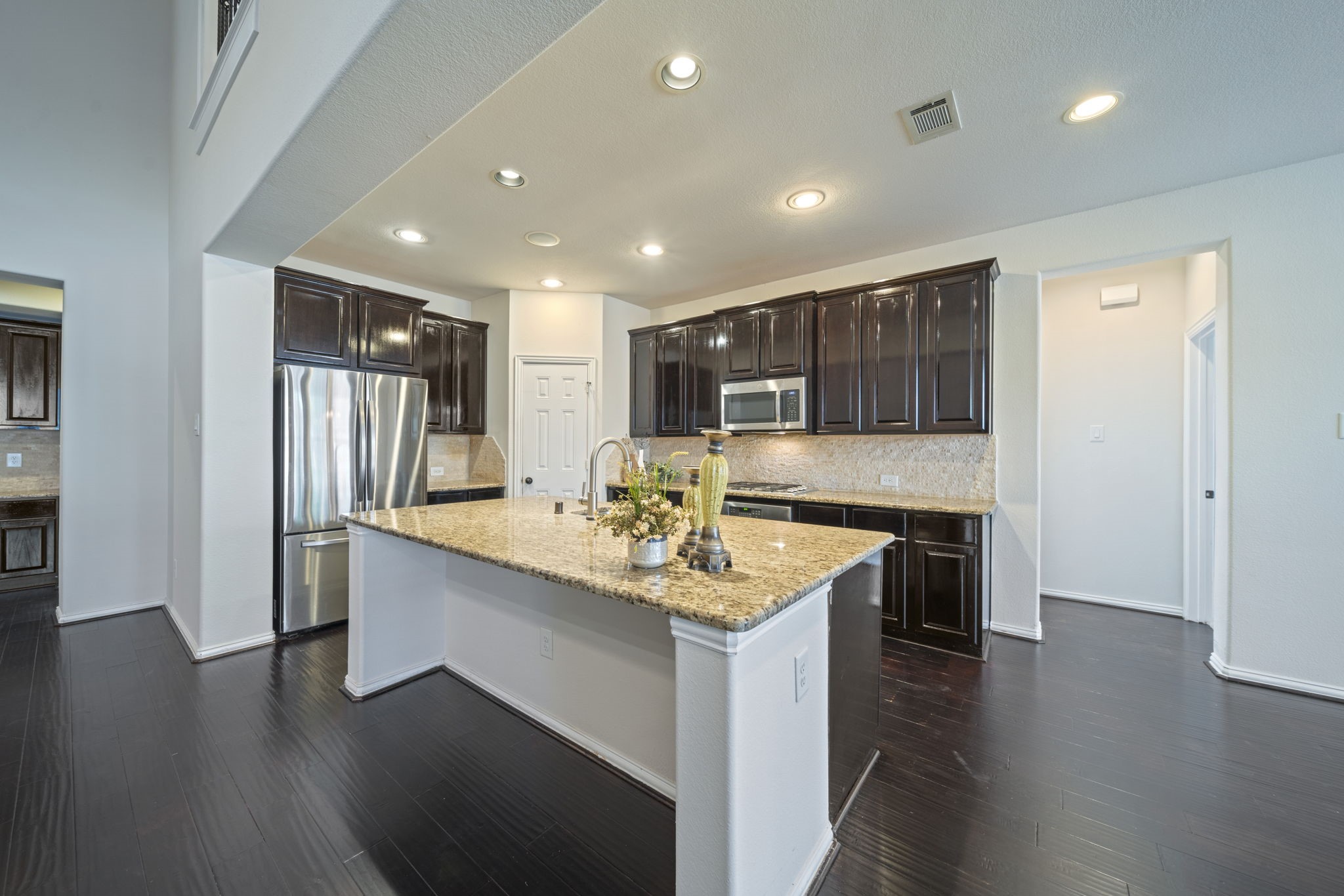 8115 Spreadwing Street Conroe, TX 77385 - Photo 16 of 45 a kitchen with stainless steel appliances granite countertop a sink stove and refrigerator