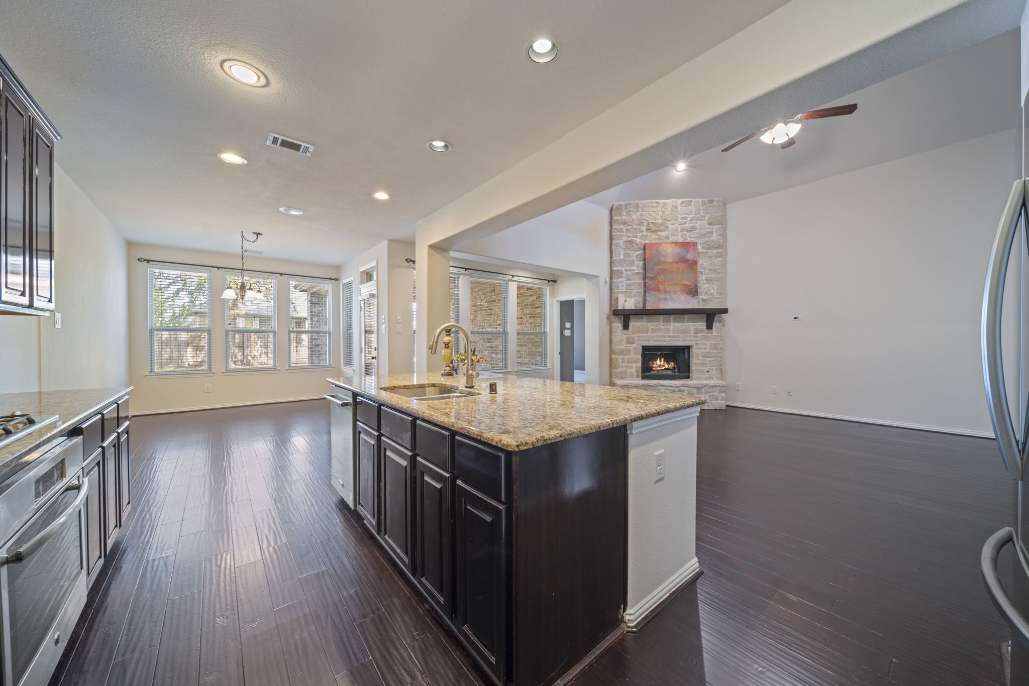 8115 Spreadwing Street Conroe, TX 77385 - Photo 19 of 45 a kitchen with a stove and wooden floor