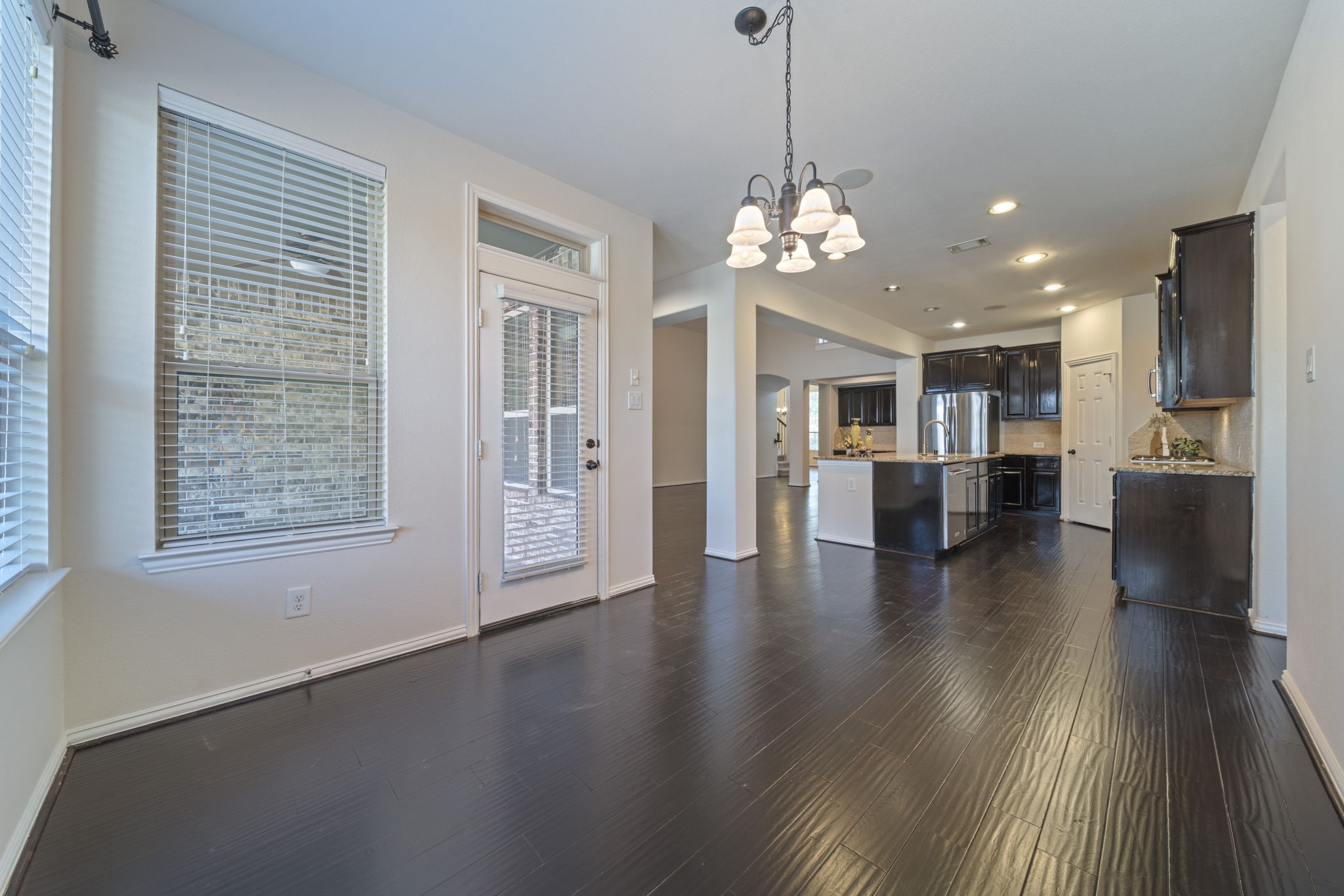 8115 Spreadwing Street Conroe, TX 77385 - Photo 21 of 45 a view of a big room with wooden floor and windows