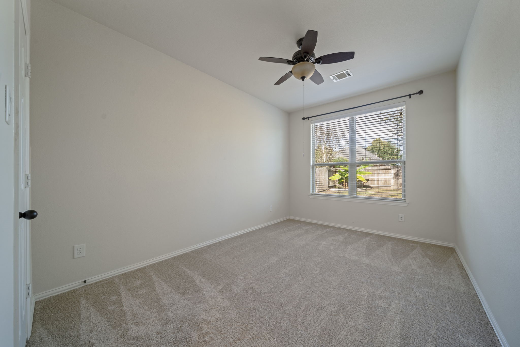 8115 Spreadwing Street Conroe, TX 77385 - Photo 23 of 45 a view of an empty room and window