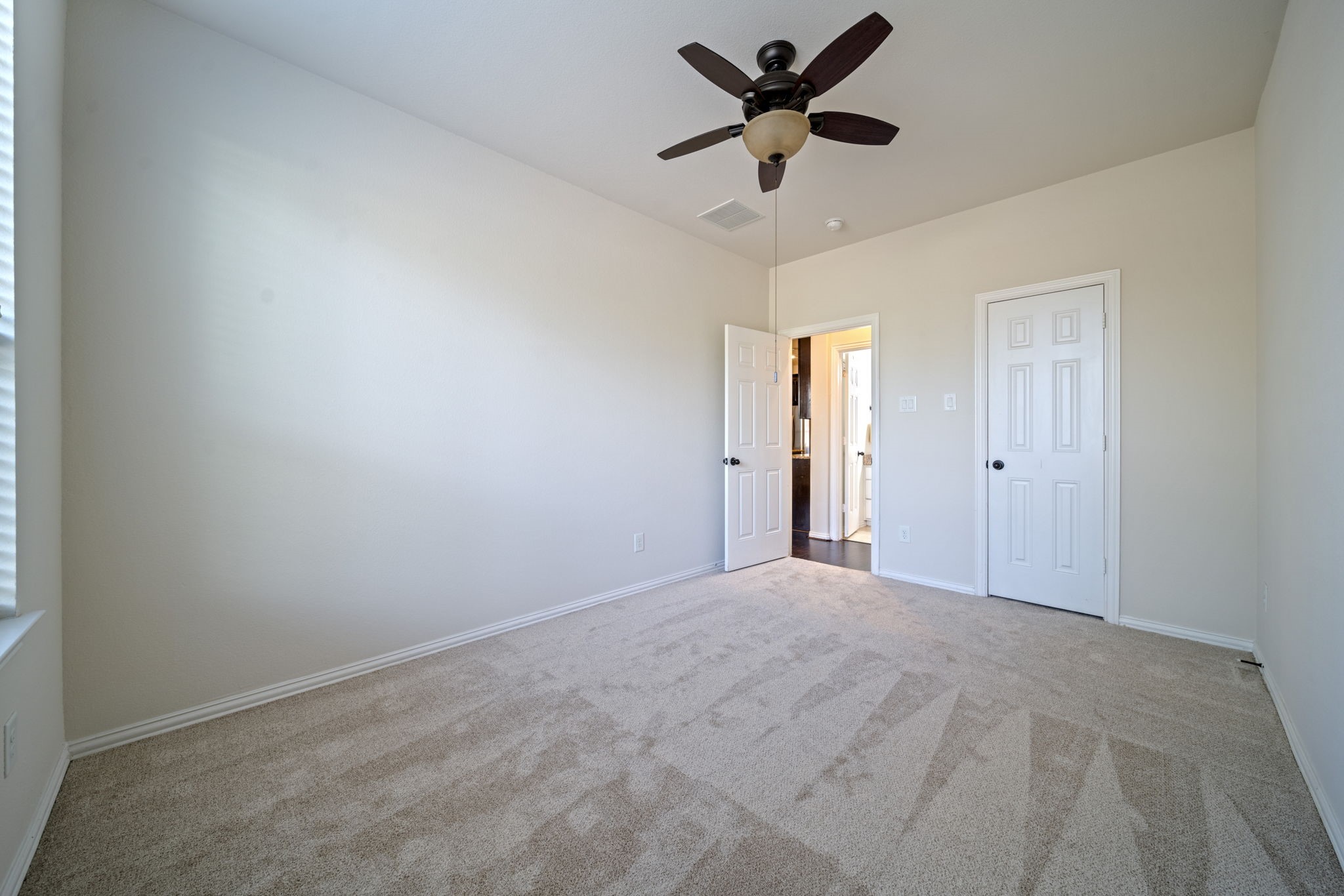 8115 Spreadwing Street Conroe, TX 77385 - Photo 24 of 45 a view of a big room with a ceiling fan and a window