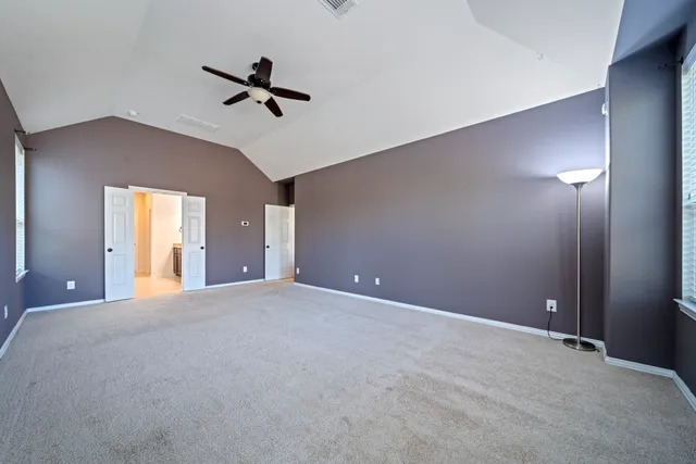 a view of an empty room with a ceiling fan