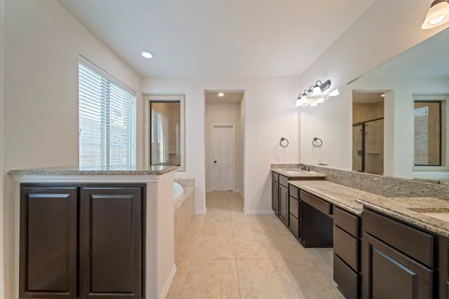 a large kitchen with granite countertop a stove and a sink