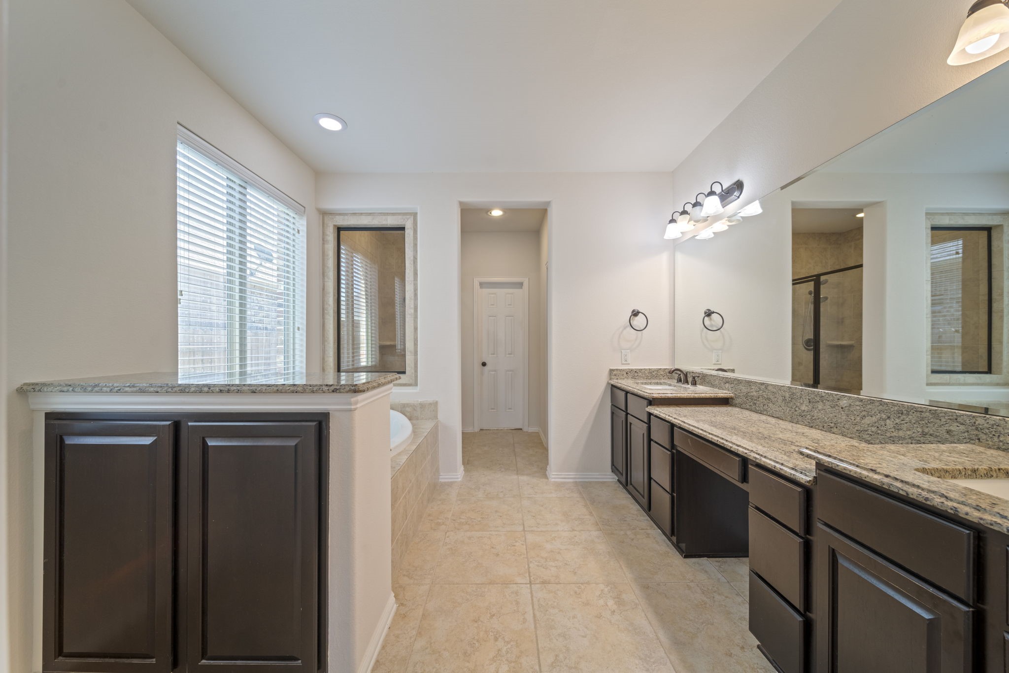 8115 Spreadwing Street Conroe, TX 77385 - Photo 27 of 45 a large kitchen with granite countertop a stove and a sink