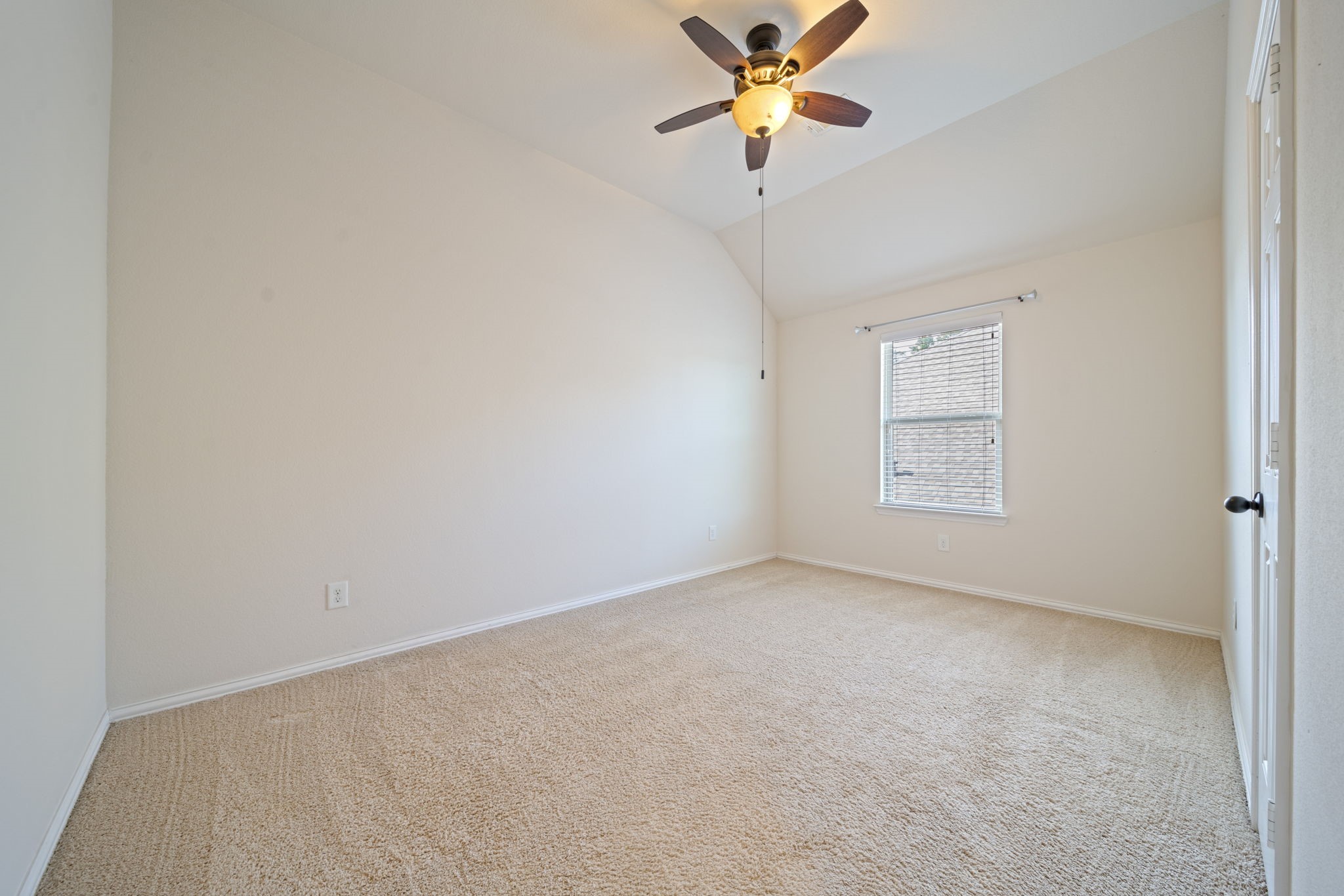 8115 Spreadwing Street Conroe, TX 77385 - Photo 40 of 45 an empty room with a window and a fan