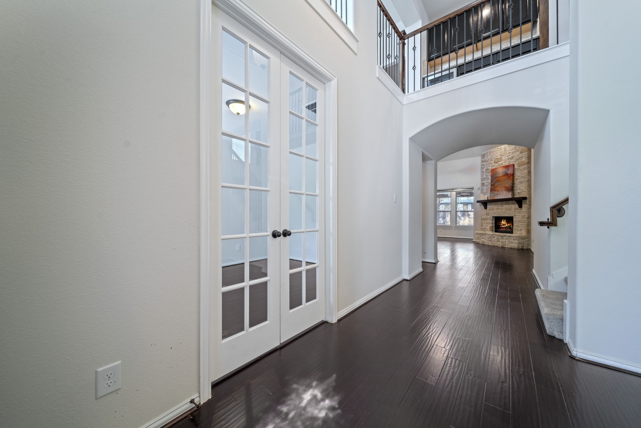 8115 Spreadwing Street Conroe, TX 77385 - Photo 4 of 45 a view of a hallway with wooden floor and a living room