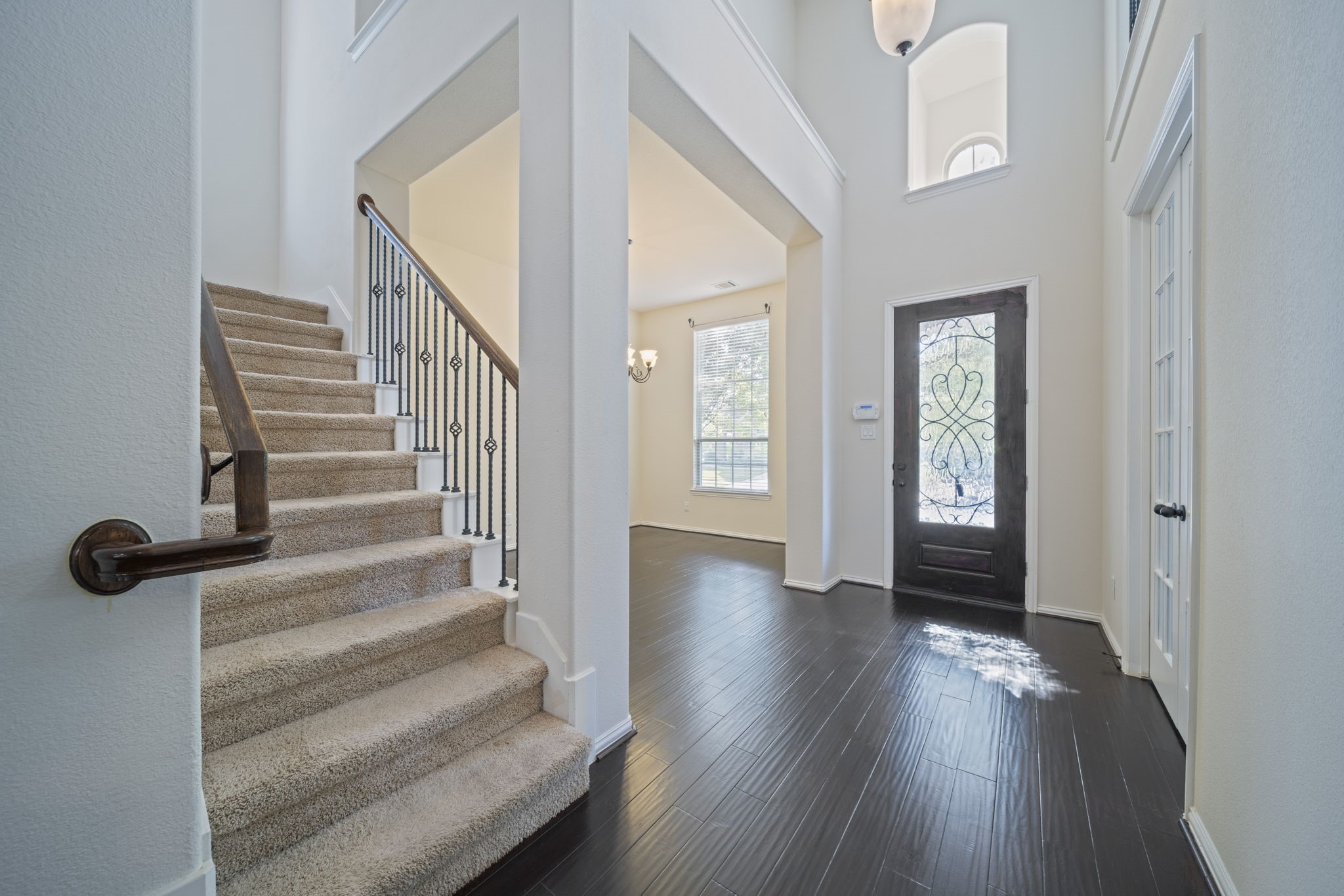 8115 Spreadwing Street Conroe, TX 77385 - Photo 5 of 45 a view of an entryway with wooden floor and stairs