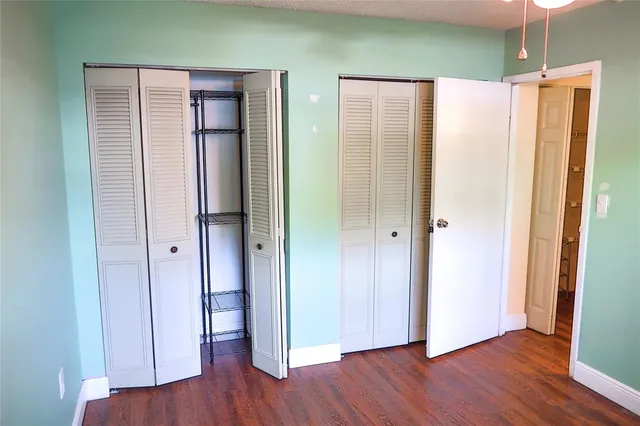 a view of a room with wooden floor and window