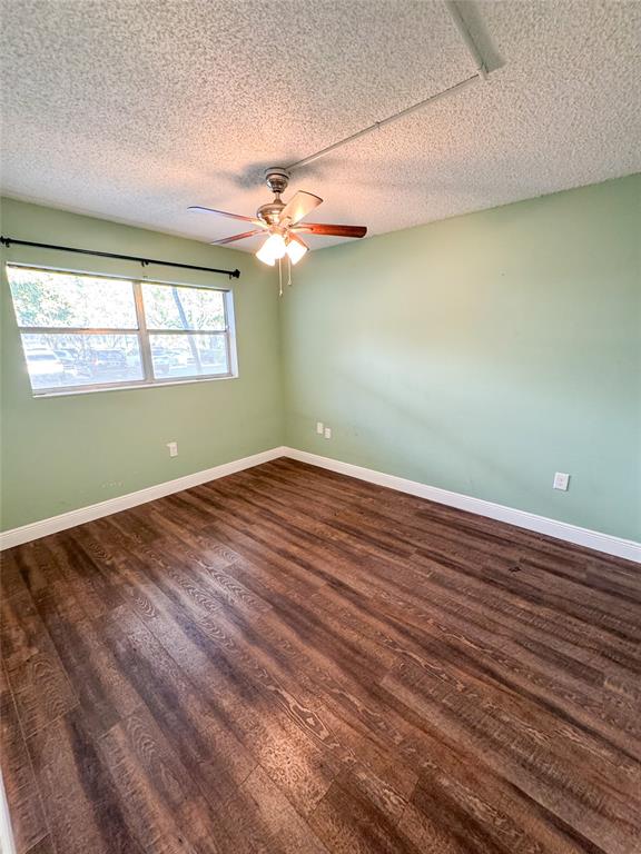 8351 Sands Point Boulevard, Unit A104 Tamarac, FL 33321 - Photo 12 of 18 an empty room with a window and ceiling fan