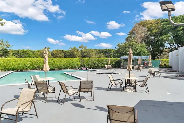 a view of a patio with chairs and table