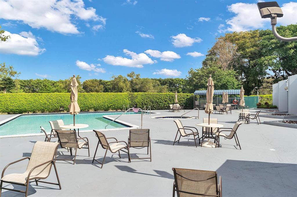 8351 Sands Point Boulevard, Unit A104 Tamarac, FL 33321 - Photo 15 of 18 a view of a patio with chairs and table