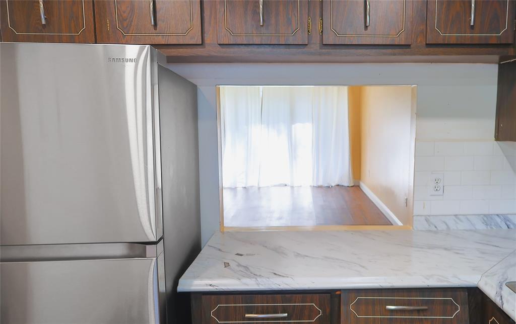 8351 Sands Point Boulevard, Unit A104 Tamarac, FL 33321 - Photo 6 of 18 a view of a kitchen with wooden floor