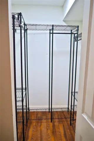 a view of walk in closet with empty racks