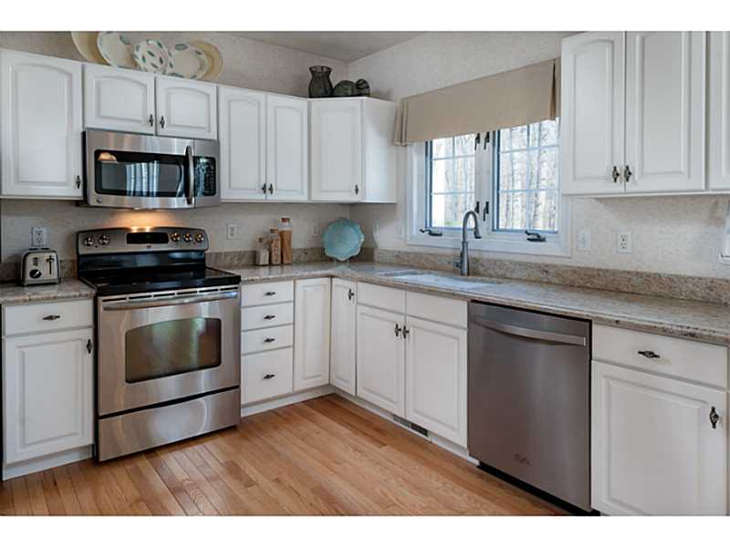 Kitchen. The bright and sunny kitchen was remodeled in 2012 with new granite counters, stainless appliances and hardwood flooring. All of the appliances will remain with the home.