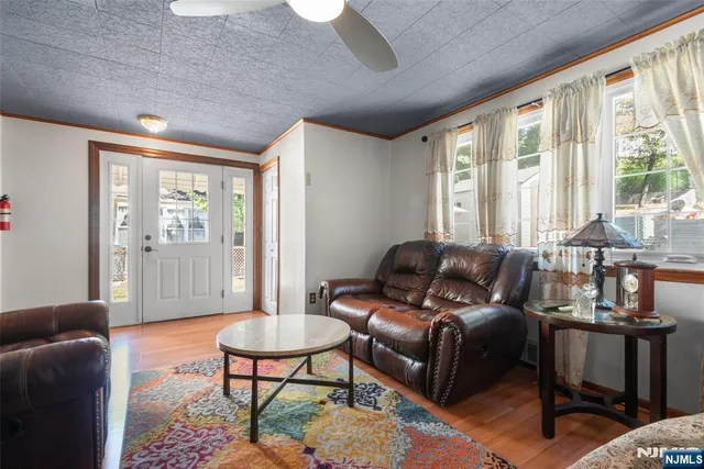 a living room with furniture a table and a large window