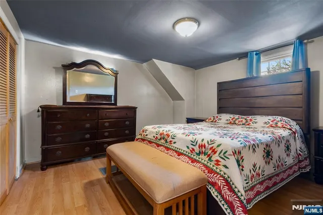 a bedroom with a bed and a dresser