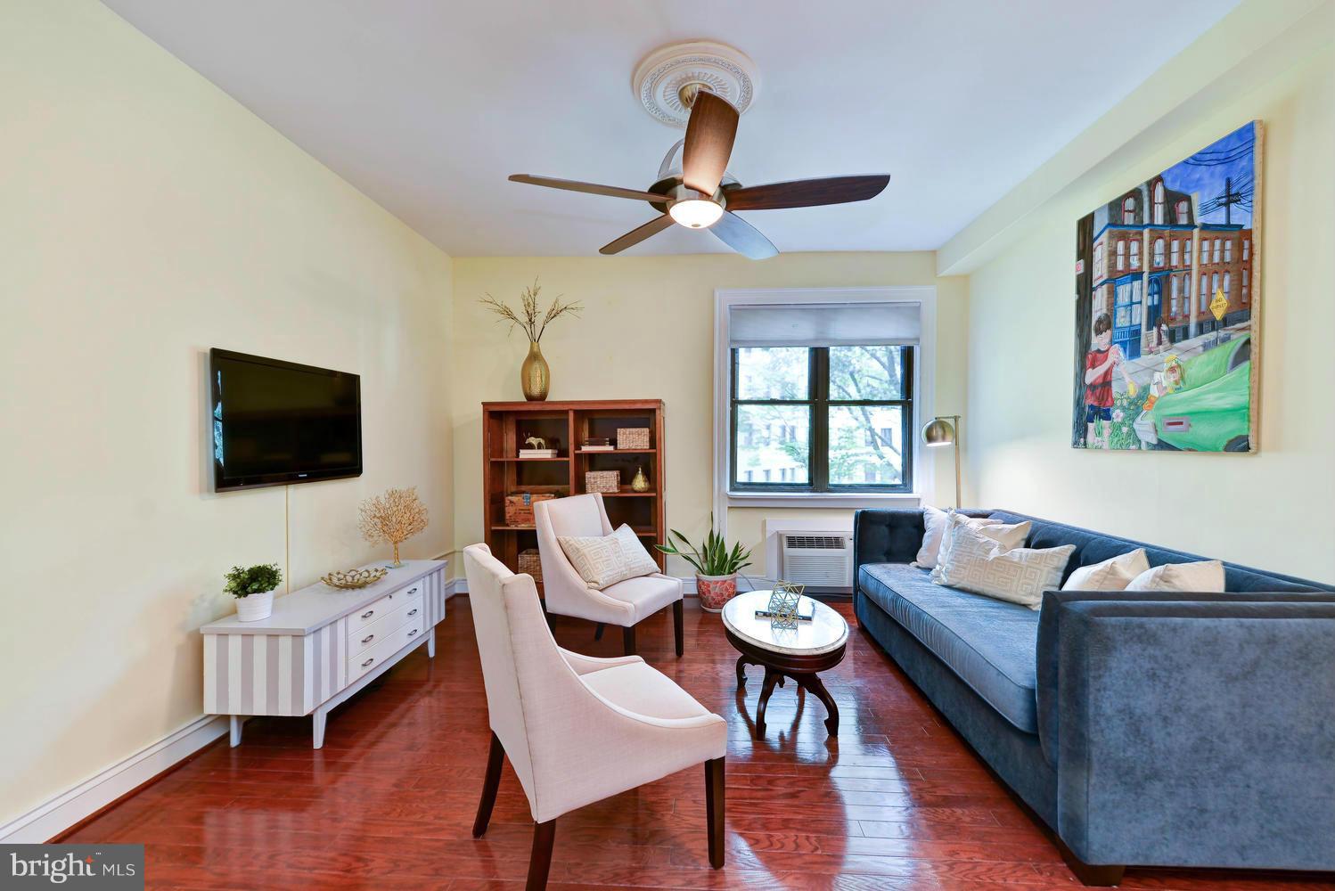 3100 Connecticut Avenue Northwest, Unit 304 Washington, DC 20008 - Photo 2 of 15 a living room with furniture a window and a flat screen tv