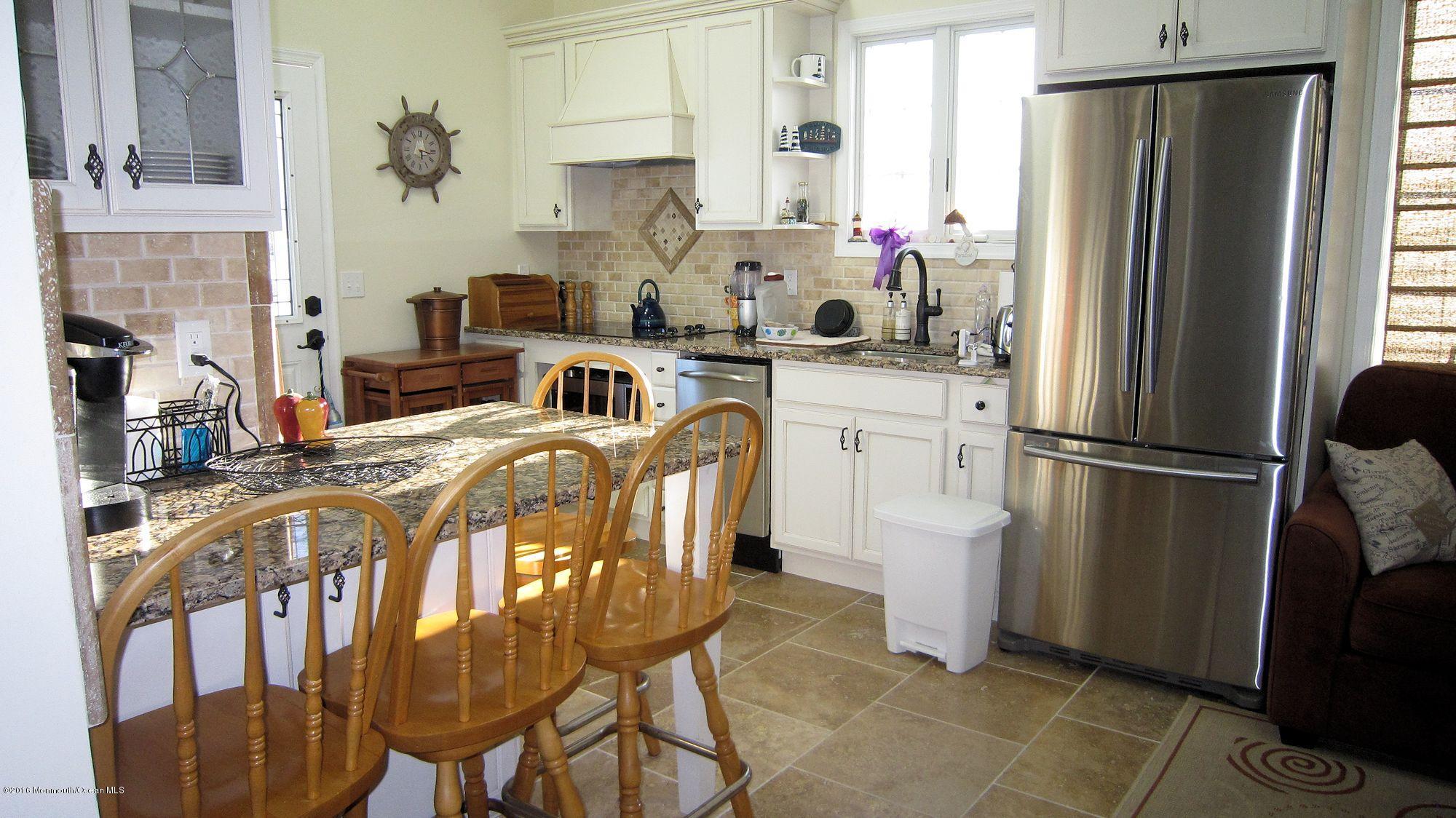 104 West Plover Way Lavallette, NJ 08735 - Photo 4 of 12 a kitchen with stainless steel appliances a refrigerator sink and cabinets