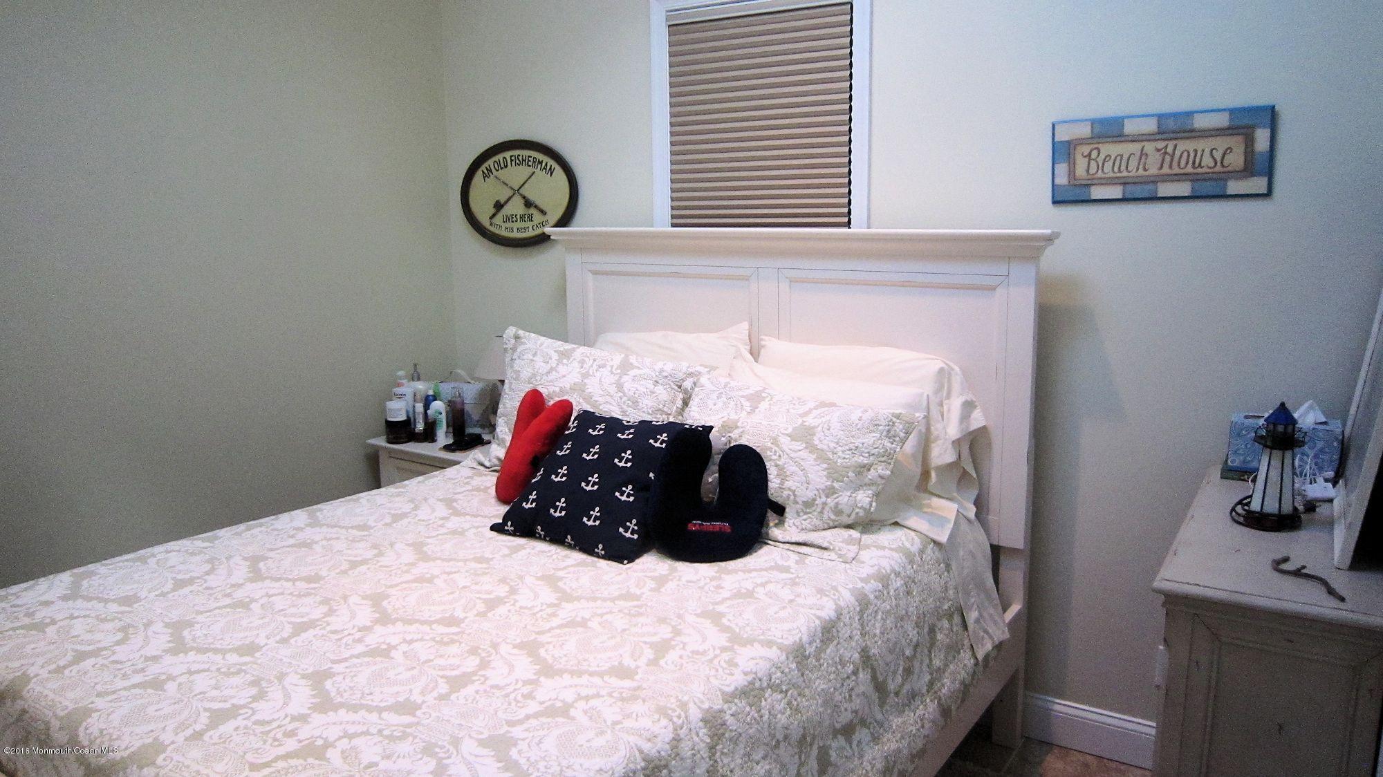 104 West Plover Way Lavallette, NJ 08735 - Photo 9 of 12 a bedroom with a bed and a table