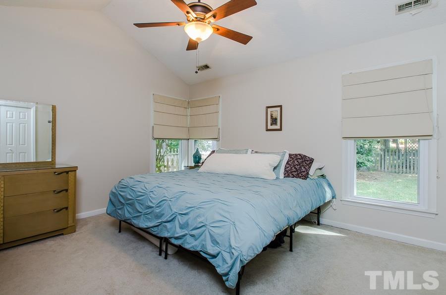 5521 Edgebury Road Raleigh, NC 27613 - Photo 11 of 19 a bedroom with a bed and a dresser