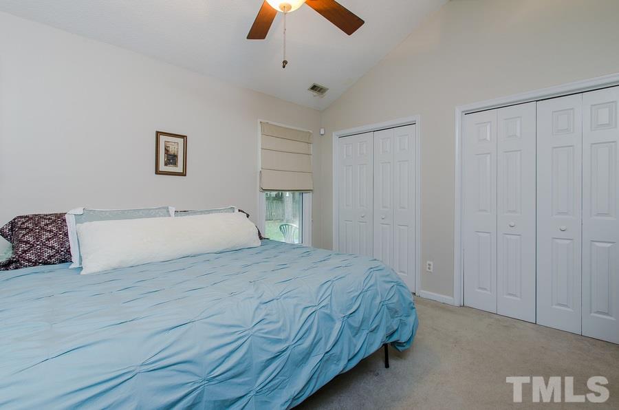 5521 Edgebury Road Raleigh, NC 27613 - Photo 12 of 19 a bedroom with a bed and a ceiling fan