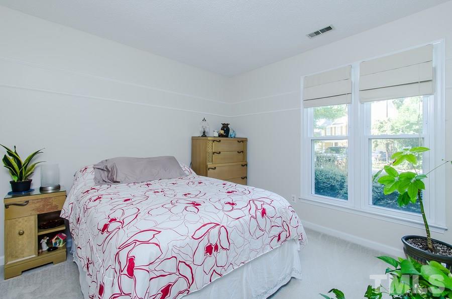 5521 Edgebury Road Raleigh, NC 27613 - Photo 13 of 19 a bedroom with a bed and a window