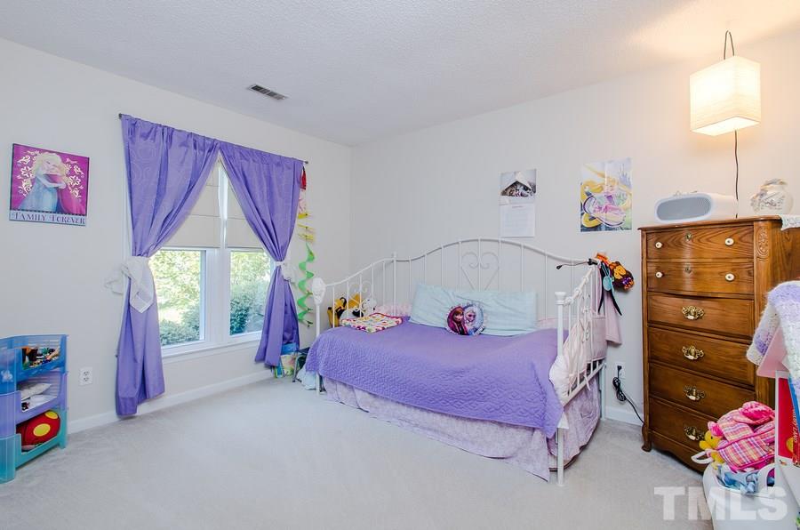 5521 Edgebury Road Raleigh, NC 27613 - Photo 14 of 19 a bedroom with a bed and a window
