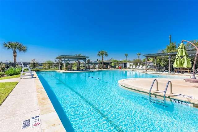 an aerial view of a house with outdoor space swimming pool and ocean view