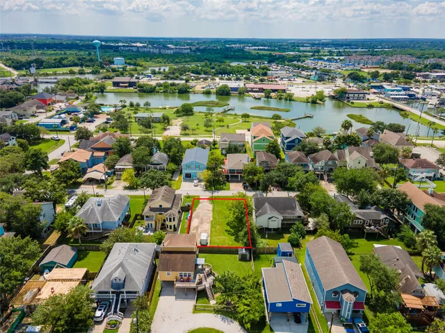 an aerial view of a houses with a lake view
