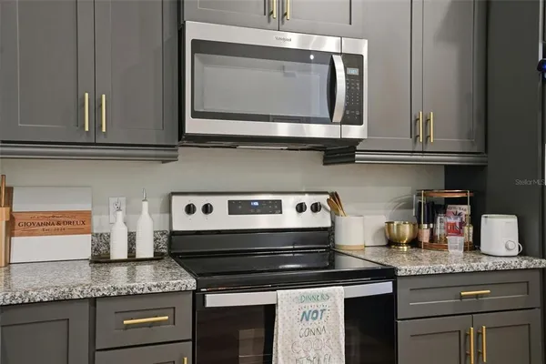 a kitchen with granite countertop a sink and cabinets